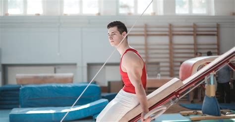 Young sportsman sitting on gymnastic equipment · Free Stock Photo