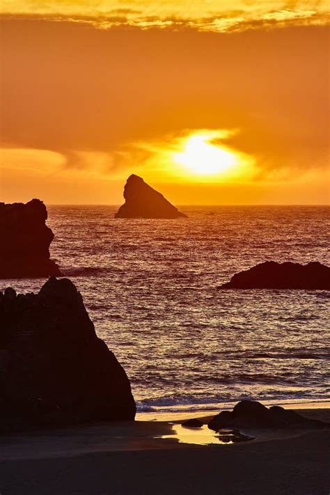 golden sunset  rock formation  secluded beach aerial view stock
