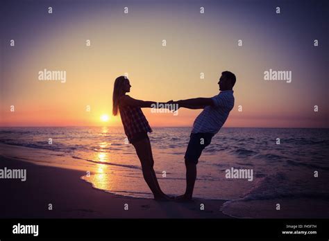 Romantic couple at sunset Stock Photo - Alamy