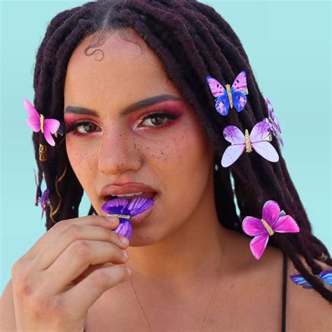 Faux locks with butterflies as hair accessories.
