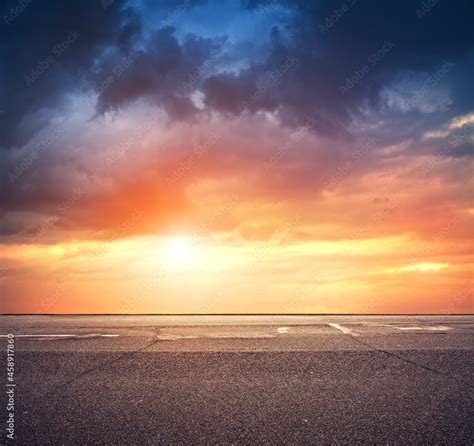 Asphalt road with dramatic sunset sky, side view Stock Photo | Adobe Stock