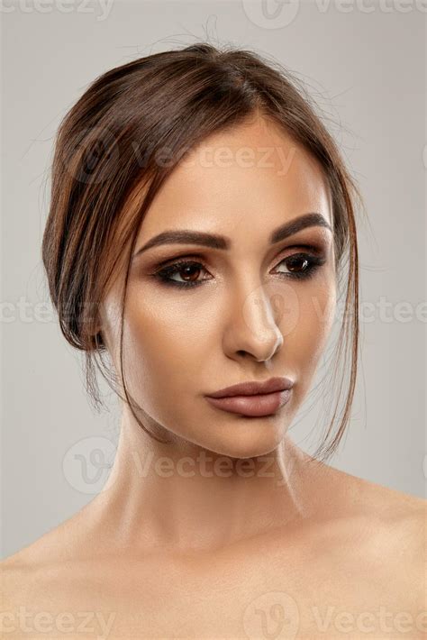 Close up portrait of a brunette nude model girl with professional