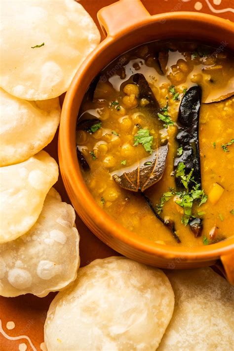 Premium Photo | Luchi cholar dal or fried bread made of flour served