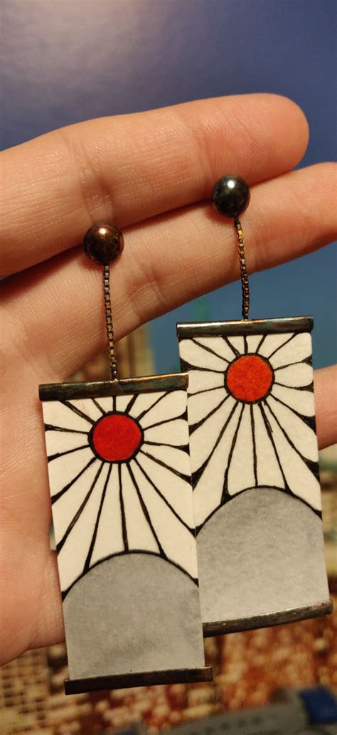 a pair of earrings that have been made to look like art