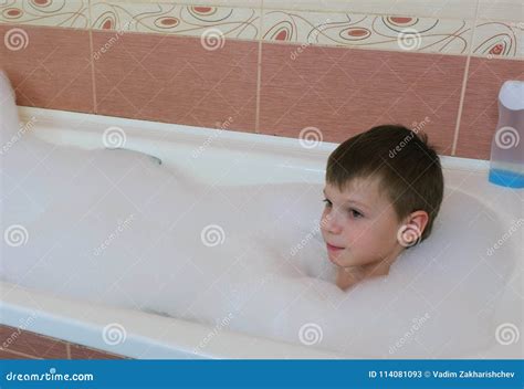 Boy 6-7 Years Lying in the Bath with White Foam. Stock Image - Image of ...