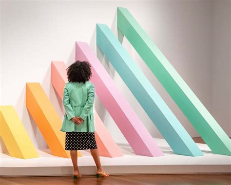 Download Visitor Contemplating Modern Art Installation Wallpaper