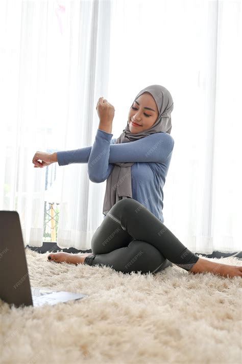 Premium Photo | Muslim woman wearing hijab relaxes practicing yoga