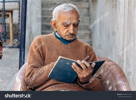 portrait  indian man reading book stock photo  shutterstock