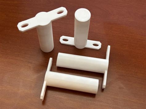 printed canvas stands white cylindrical column supports art