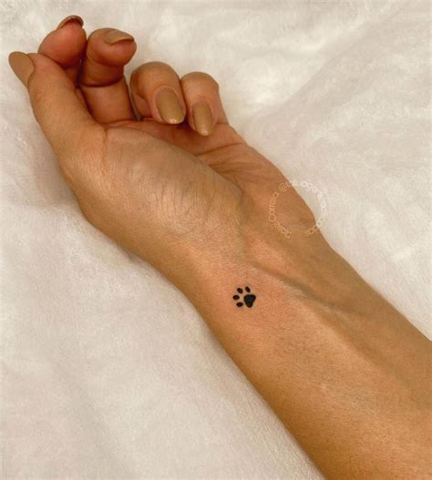 Minimalistic pet paw tattoo done on the wrist.