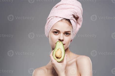 Cheerful woman cropped view of naked shoulders with towel on avocado