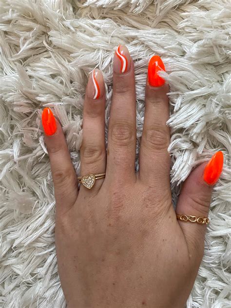 Bright Orange Nails With White Swirls Design Idea – Vibrant Guide