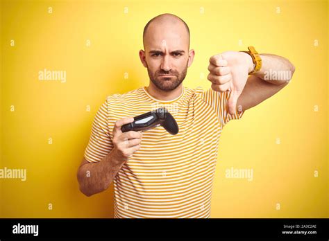 Young man playing video games using joystick gamepad over isolated ...