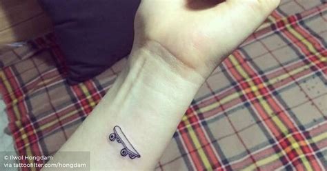 Small skateboard tattoo on the left forearm.