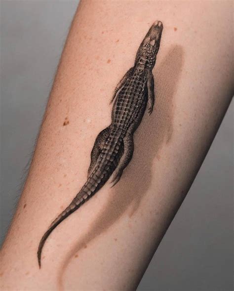 micro realistic style alligator tattoo located
