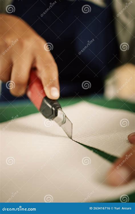 closeup  hands  designer cutting paper   knife zoom