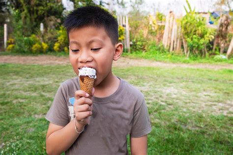 Boy eating an ice cream outside 1852455 Stock Photo at Vecteezy