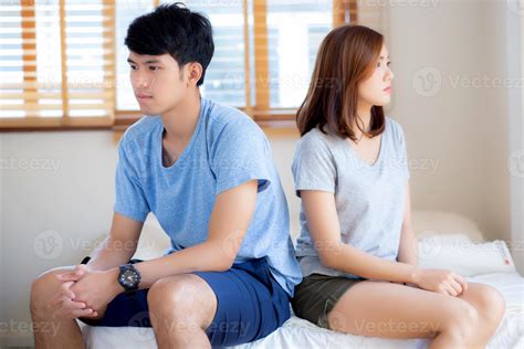Relationship of young asian couple having problem on bed in the bedroom