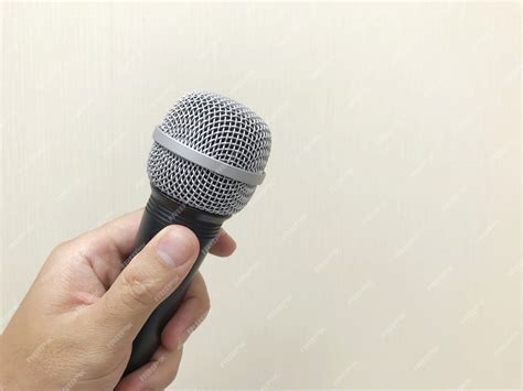 Premium Photo | Human hand holding a microphone to prepare for speaking ...