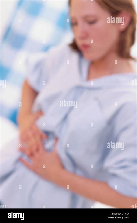 STOMACH PAIN IN A WOMAN Stock Photo - Alamy