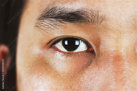 closeup eyes of asian men Stock Photo | Adobe Stock