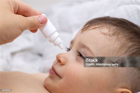 Baby Boy With Conjunctivitis Eye Drops Stock Photo - Download Image Now ...