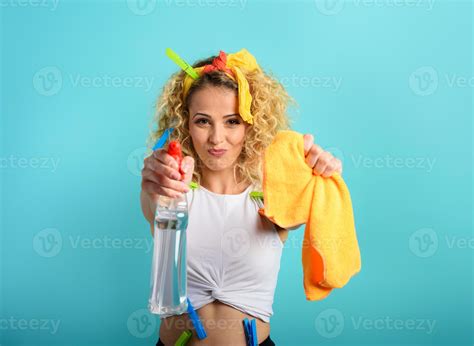 Blonde housewife splashs disinfectant to remove viruses and bacteria