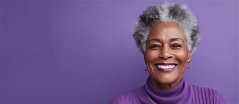 Close up portrait of happy elderly black woman smiling in front of