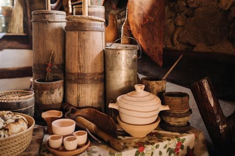 Premium Photo | Old wooden barrels and dishes on the table in the ...