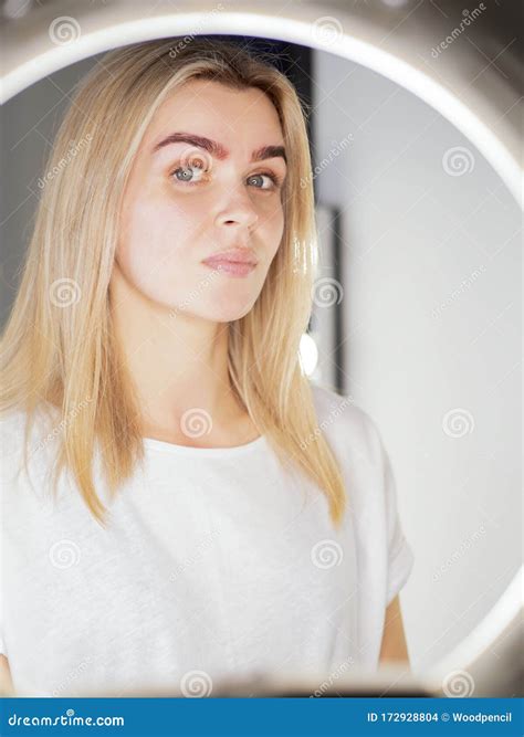 Model with Angel Eyes Looking at Camera Thru the Ring Light Lamp after