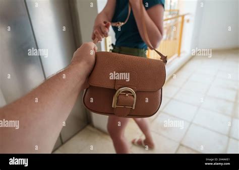 Thief snatches a bag from woman near elevator Stock Photo - Alamy