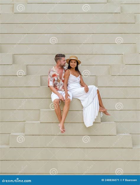 Couple Men and Woman Relaxing at an Staircase of an Modern Arabic
