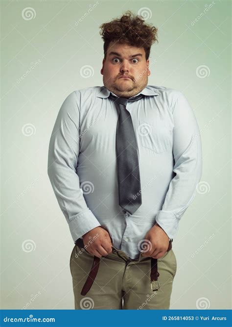 Time To Go on a Diet. an Overweight Man Sucking in His Stomach To Close