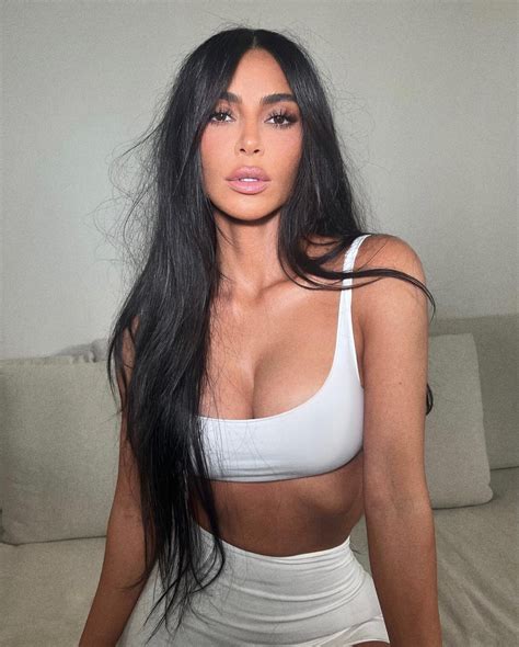 Kim Kardashian’s muscular abs pop out from her thin waist as she poses