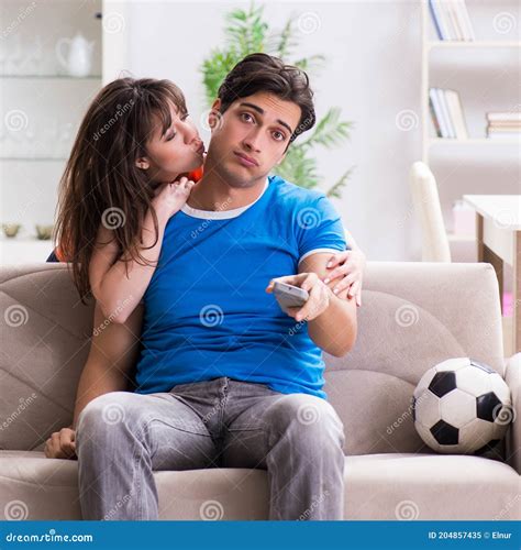 Wife Unhappy that Husband is Watching Football Stock Image - Image of