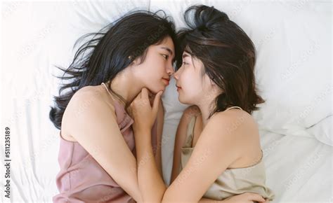 Top view of beautiful LGBT Lesbian Asian couple in Love. Two young Korean or Japanese women