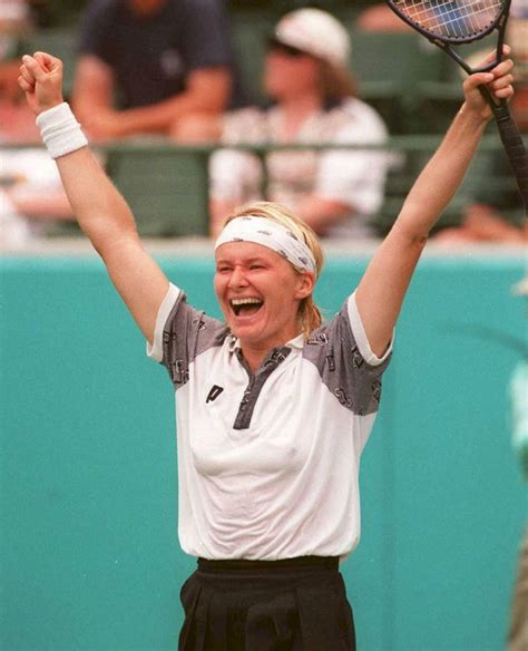 Download Jubilant Jana Novotna Raising Her Hands Triumphantly Wallpaper