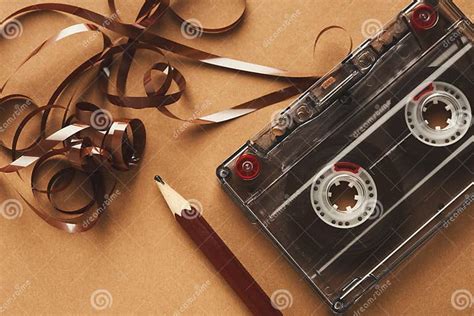 vintage cassette  pencil  rewind tape  brown background stock