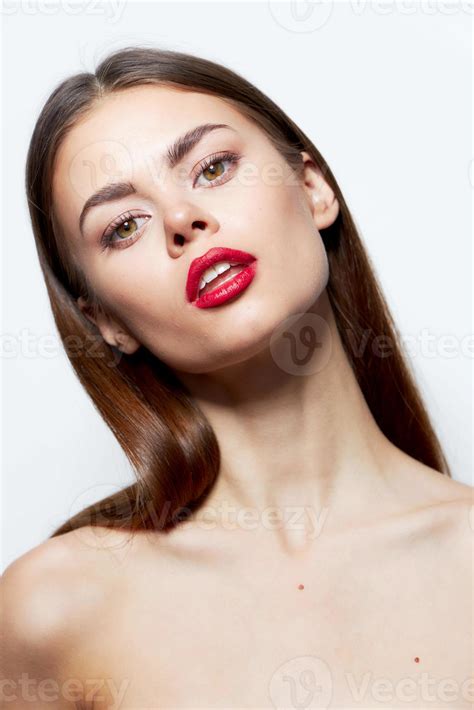 Brunette Bare shoulders red lips head tilted to one side natural look