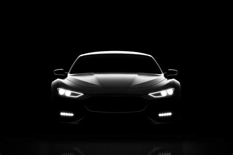 Front view dark silhouette of a modern luxury black car isolated on