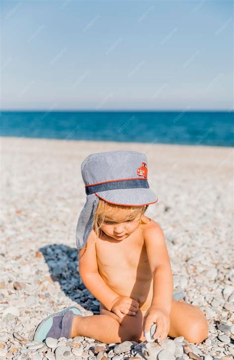 premium photo shirtless naked girl sitting  beach  sky