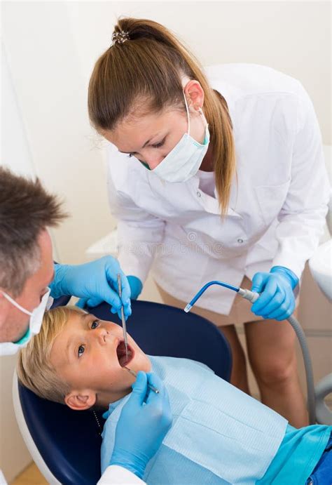 Stomatologist Guy with Female Assistant are Diagnosticating To Young ...