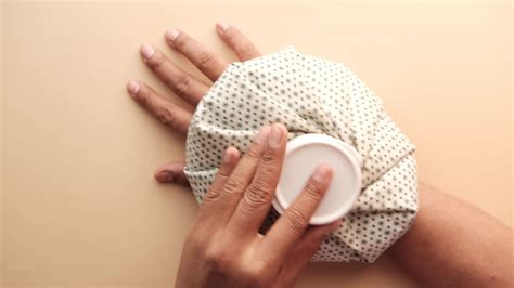 Hot water pouch on hurting wrist 14062458 Stock Video at Vecteezy