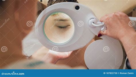 Concentrated Dermatologist Using Medical Loupe in the Clinic Stock ...