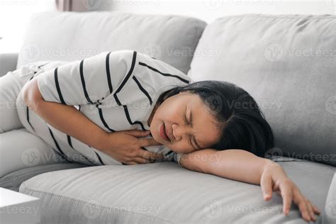 Asian woman having heart attack. Woman touching breast and having chest