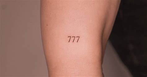 Angel number "777" tattoo located on the wrist.