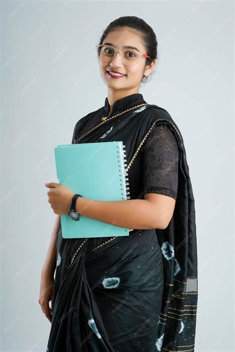 Premium Photo | Portrait of Indian lady teacher in saree stands against