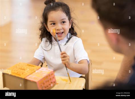 Foreign teacher teaching art class in classroom Stock Photo - Alamy