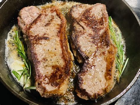 [Homemade] NY strip steaks with Montreal steak seasoning, butter