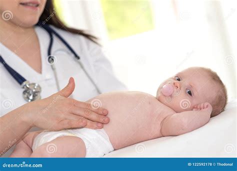 pediatrician examining baby stock photo image  colic lying
